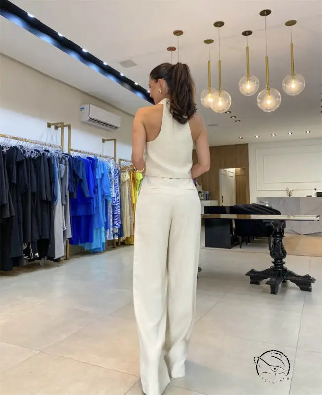 Elegant office jumpsuit set: woman’s white halter top and wide-leg pants