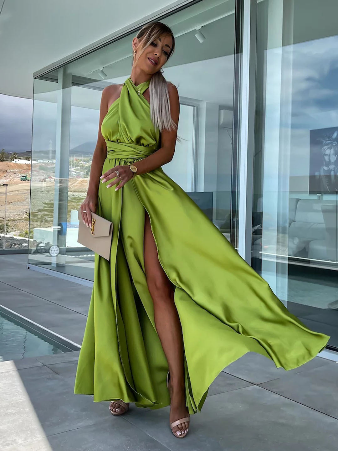 Woman in a flowing green halter dress showcasing Langry fashion for casual wear