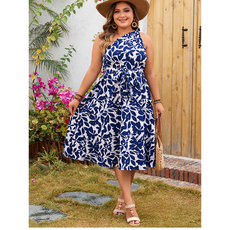 Woman in a blue and white floral dress showcasing elegant langry fashion ملابس
