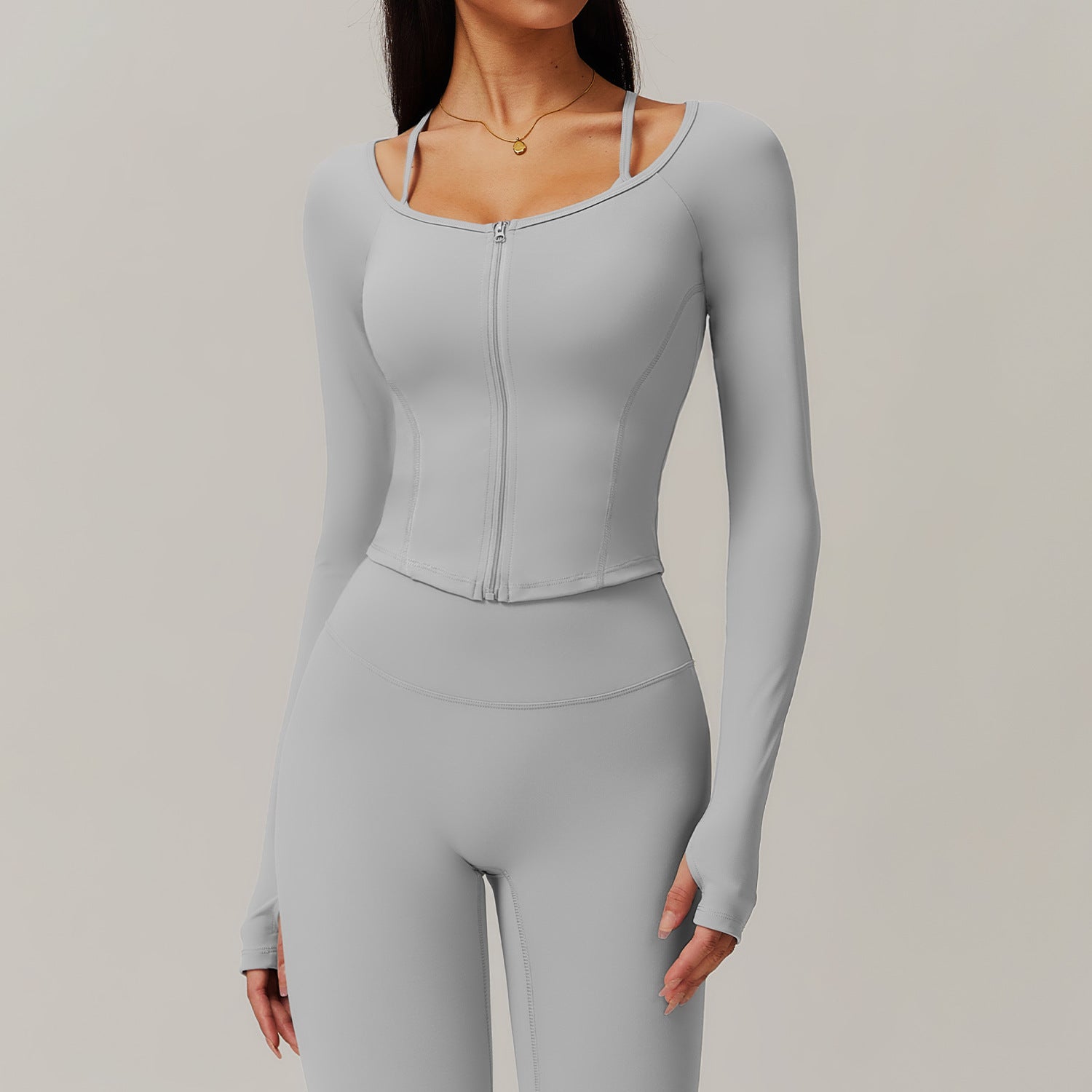 Light gray fitted athletic jumpsuit with front zipper, ideal for fitness and fashion ملابس