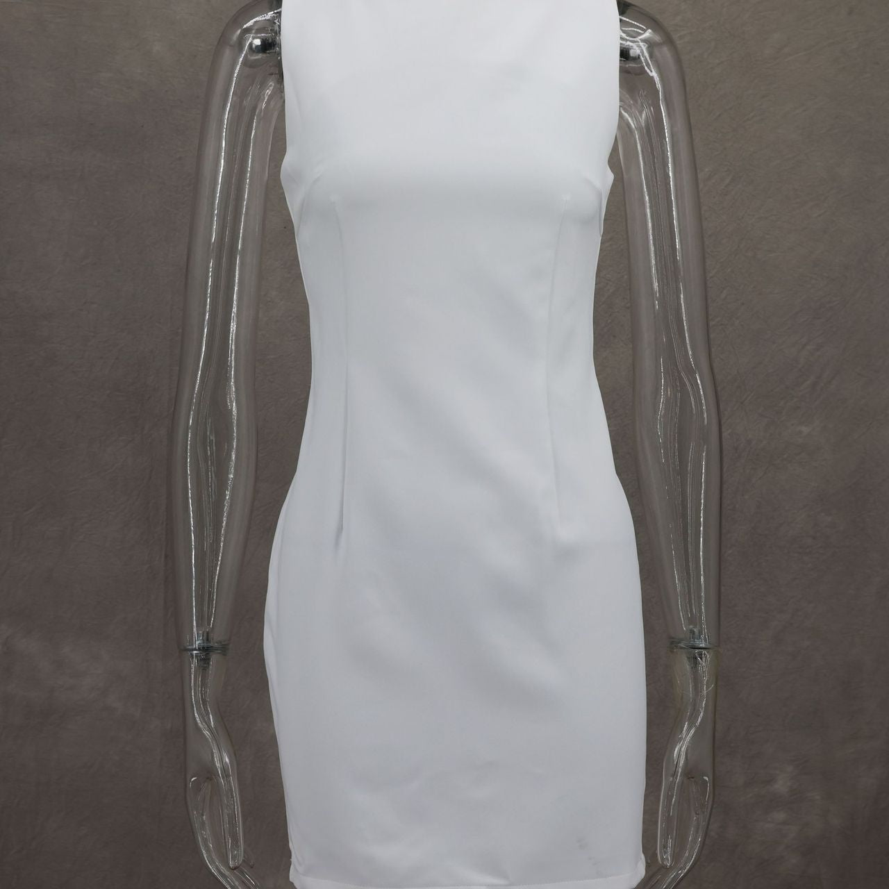 Simple white sleeveless dress on a transparent mannequin for elegant fashion ملابس