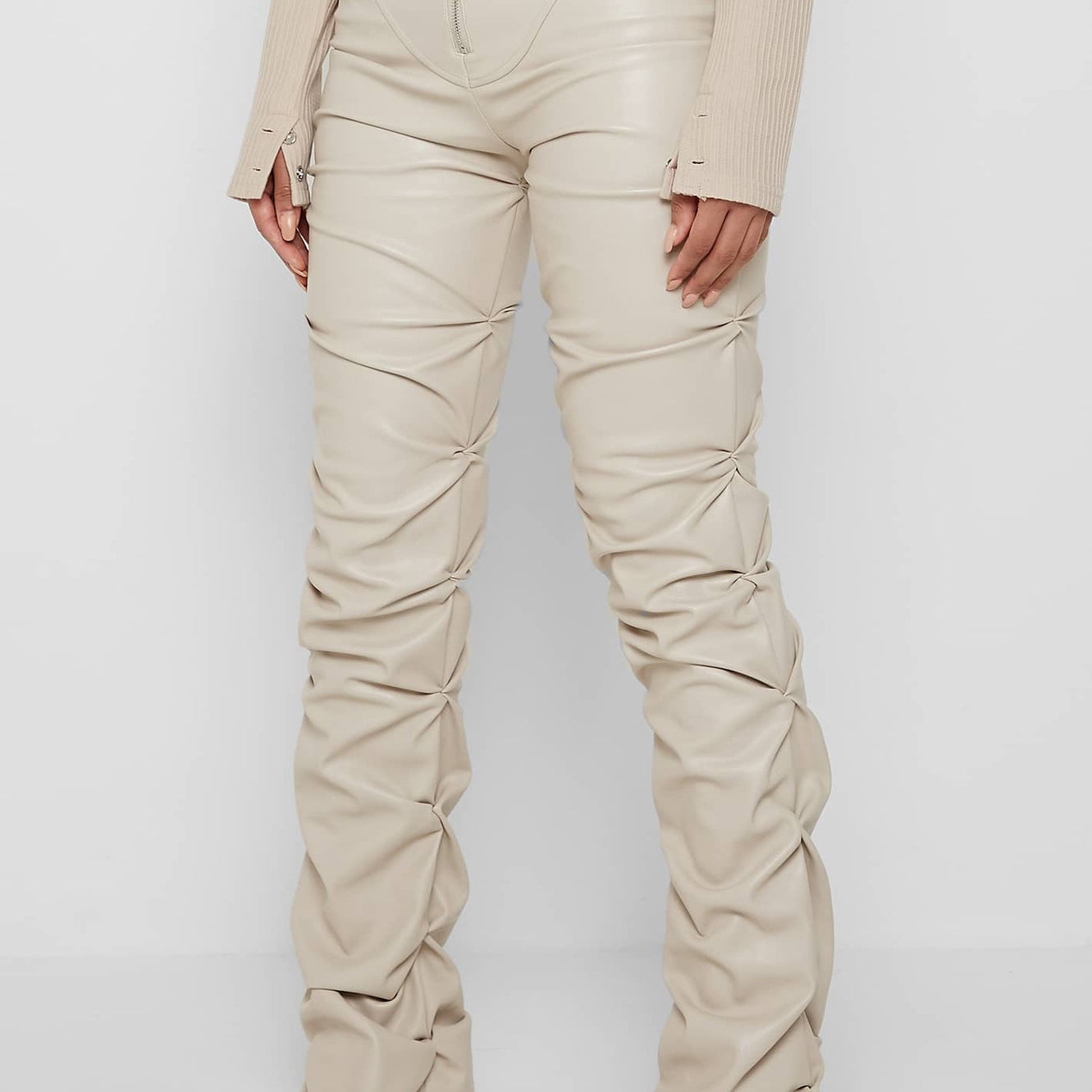 Beige ruched faux leather pants in fashion, showing style and longevity in every season