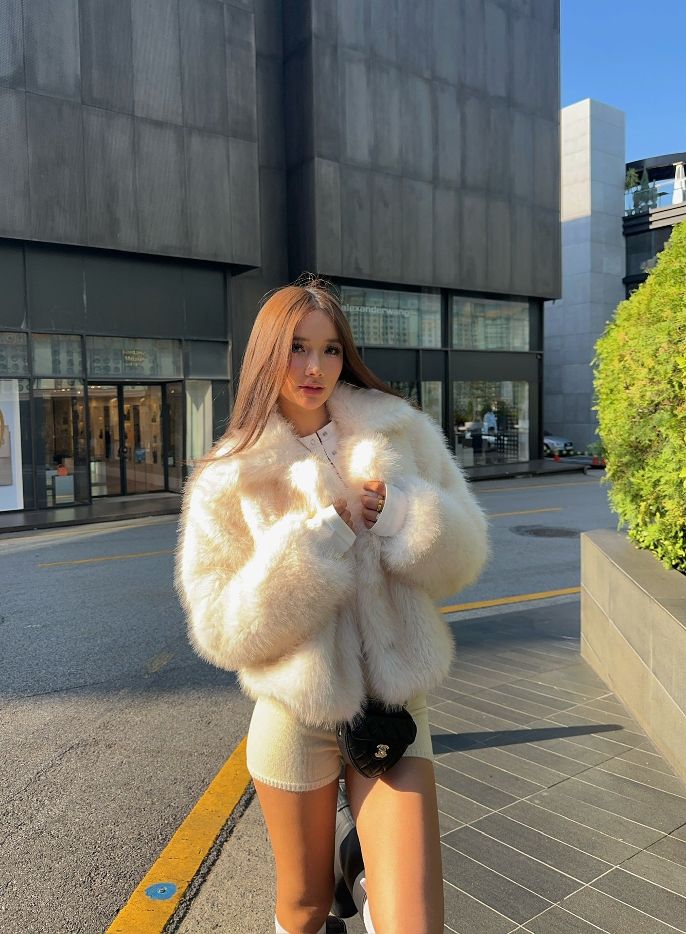 Cream faux fur oversized coat with black trim and pockets by Langry fashion