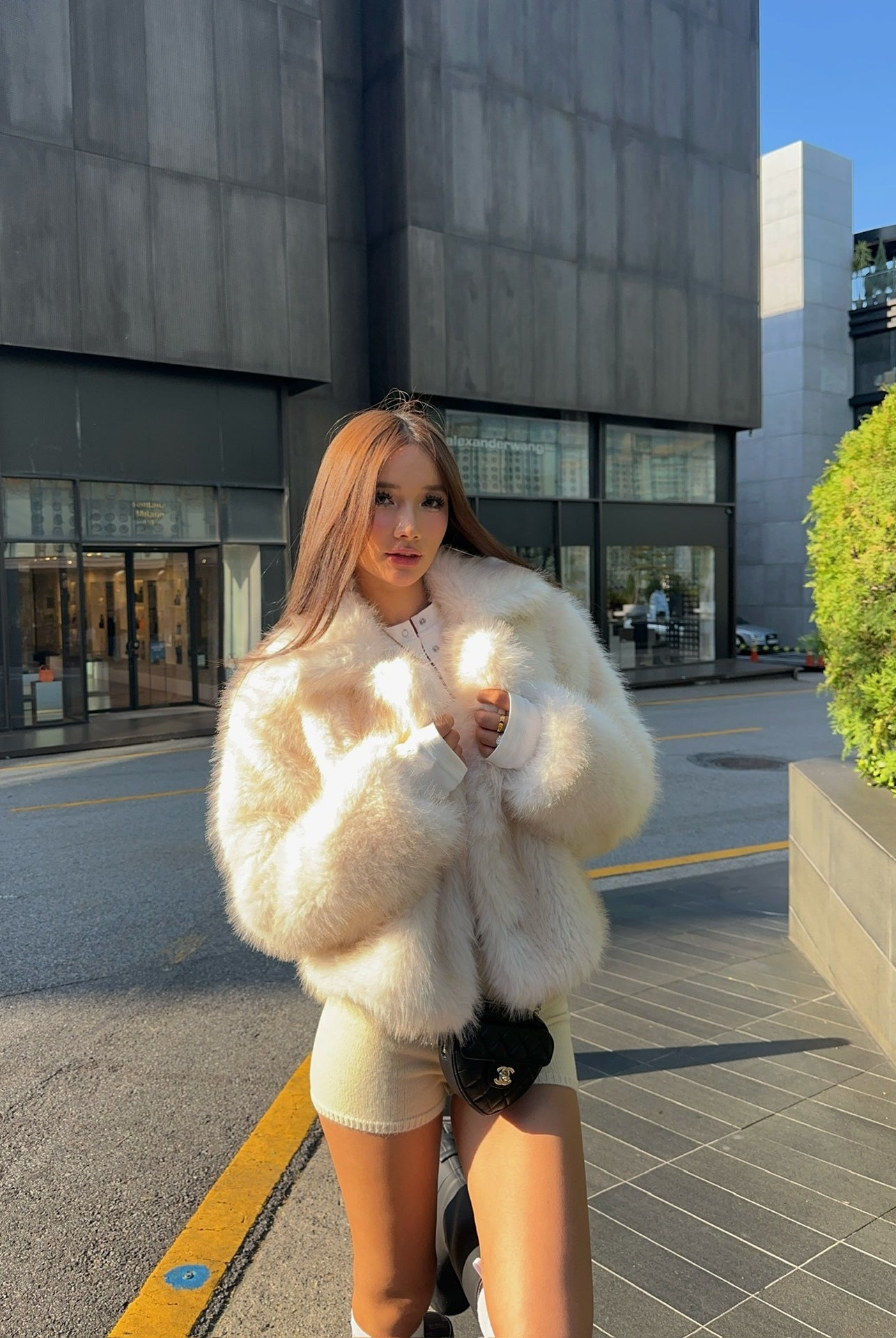 Cream faux fur oversized coat with black trim and pockets by Langry fashion