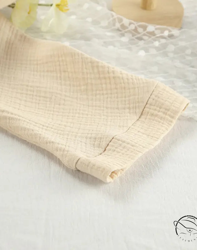 Close-up of beige textured winter pure cotton pajama sleeve with cuff