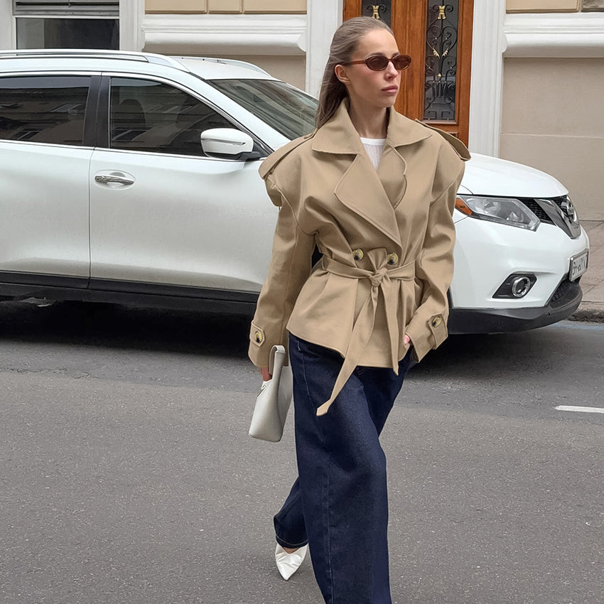Trendy beige khaki trench coat with double-breasted fashion design and belt detail