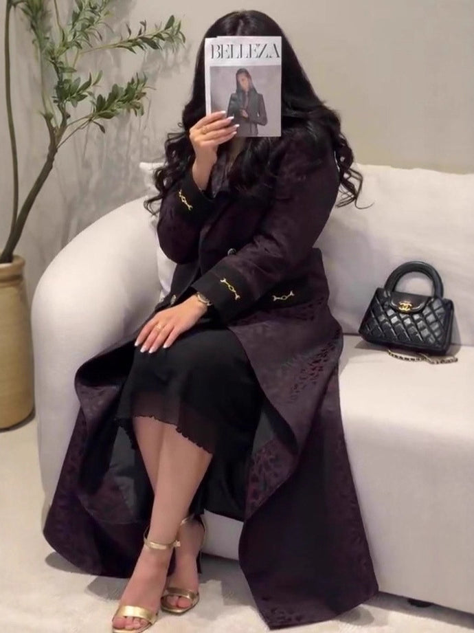 Black quilted handbag with gold-tone hardware in Langry fashion trench coat