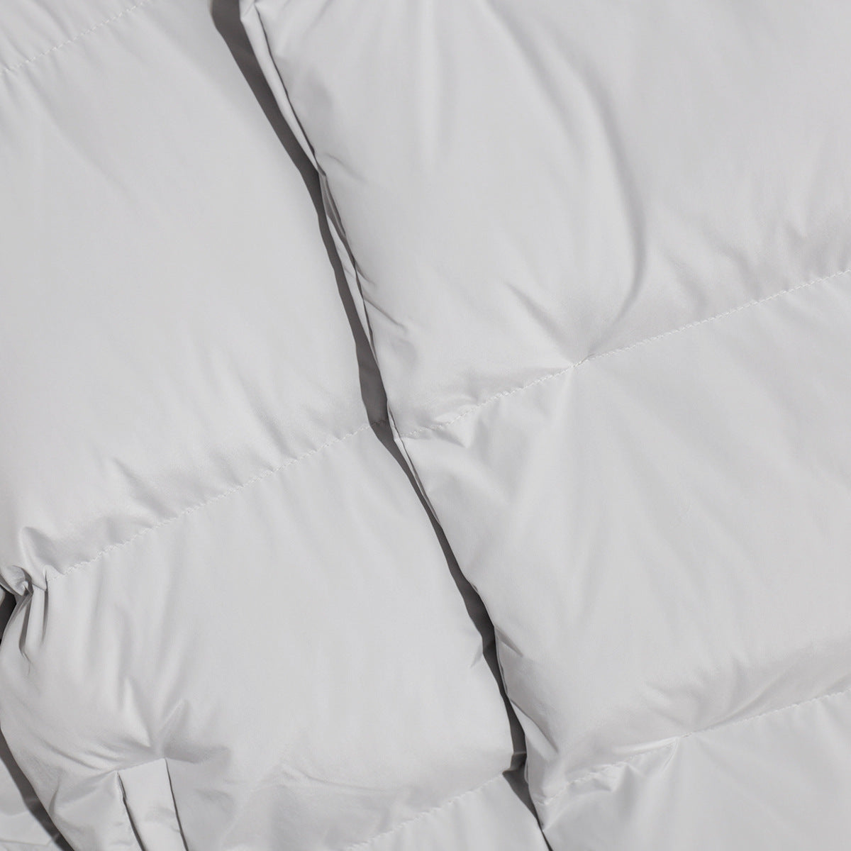 Padded white fabric of the Cotton Coat Jacket, perfect for stylish fashion ملابس