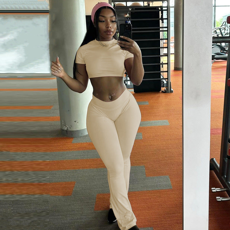 Woman modeling a slim fit high waist suit in matching crop top and pants for elegant style