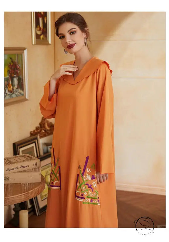 Beautiful orange long-sleeved fashion dress with hood and floral bag