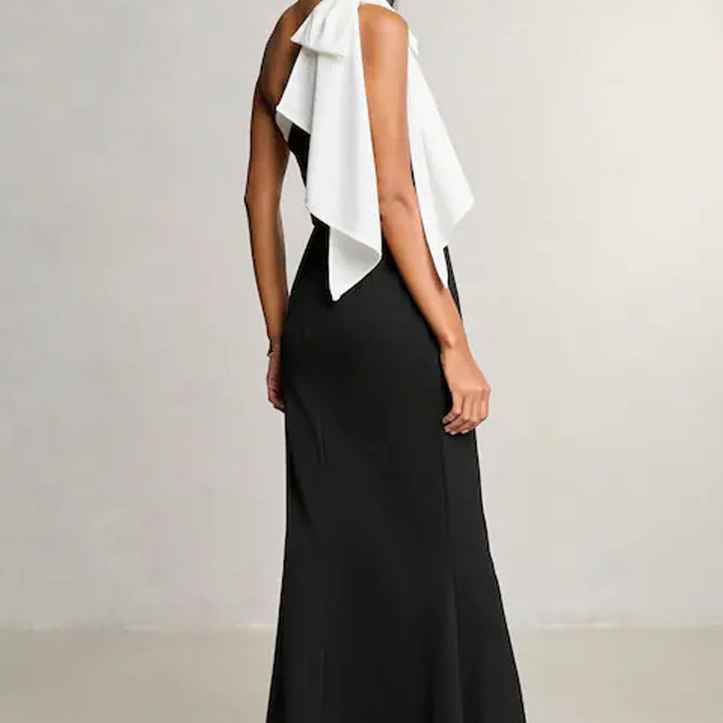 Elegant black and white evening gown with ruffled back, perfect for fashion or ملابس