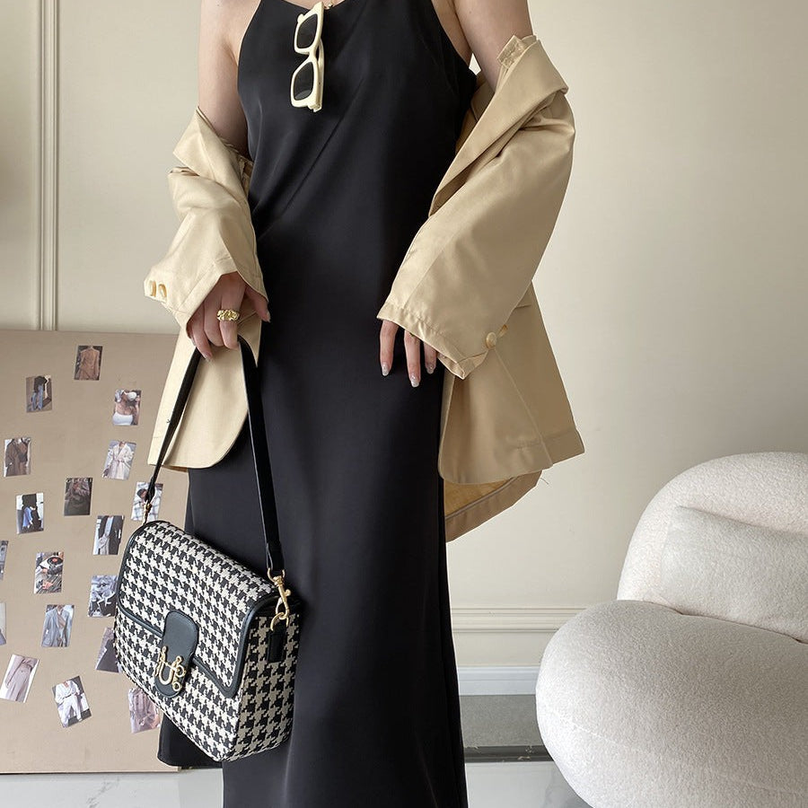 Obsidian black French acetate satin dress with gold hardware and houndstooth bag