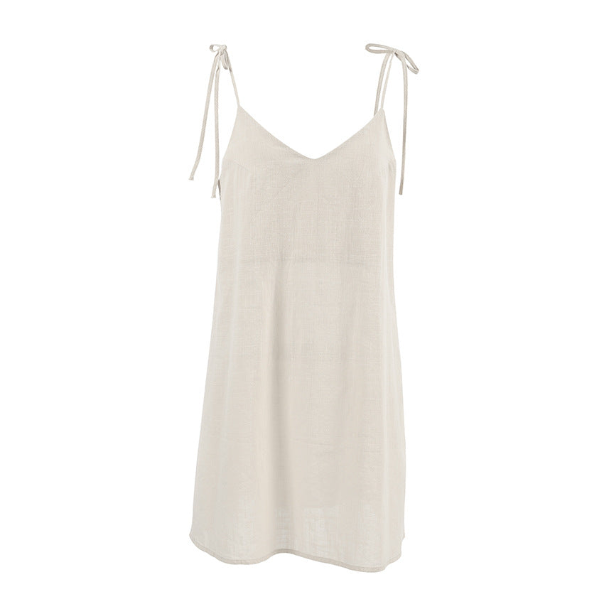 Light beige v-neck slip dress with spaghetti straps, perfect for casual summer fashion and ملابس
