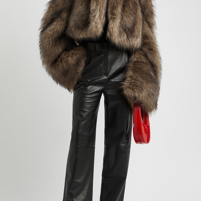 Elegant woman wearing Fur Short Coat with leather pants and red purse, stylish fashion look