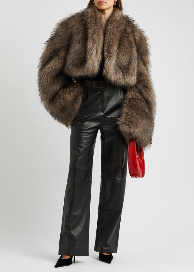 Elegant woman wearing Fur Short Coat with leather pants and red purse, stylish fashion look