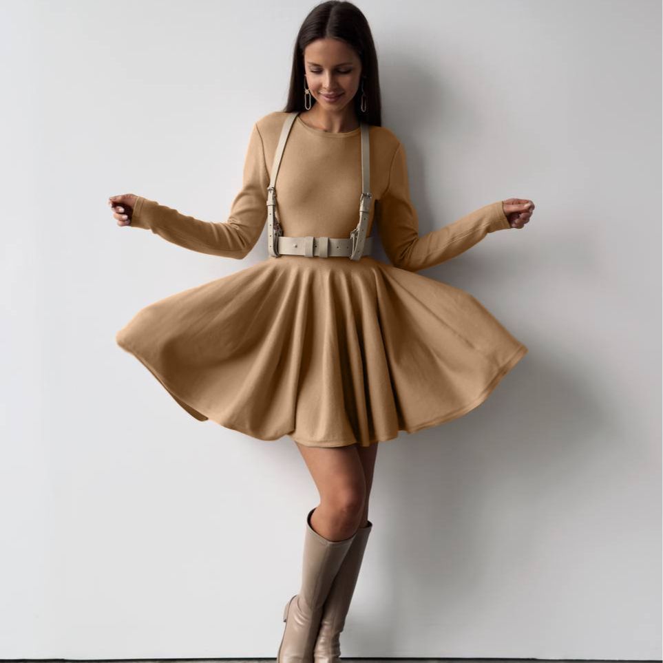 Woman in tan harness dressed in a beautiful woolen knitted dress showcasing elegance