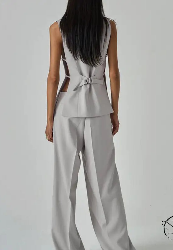 Sleek light gray long sleeve fashion jumpsuit with peplum waist and back cutouts