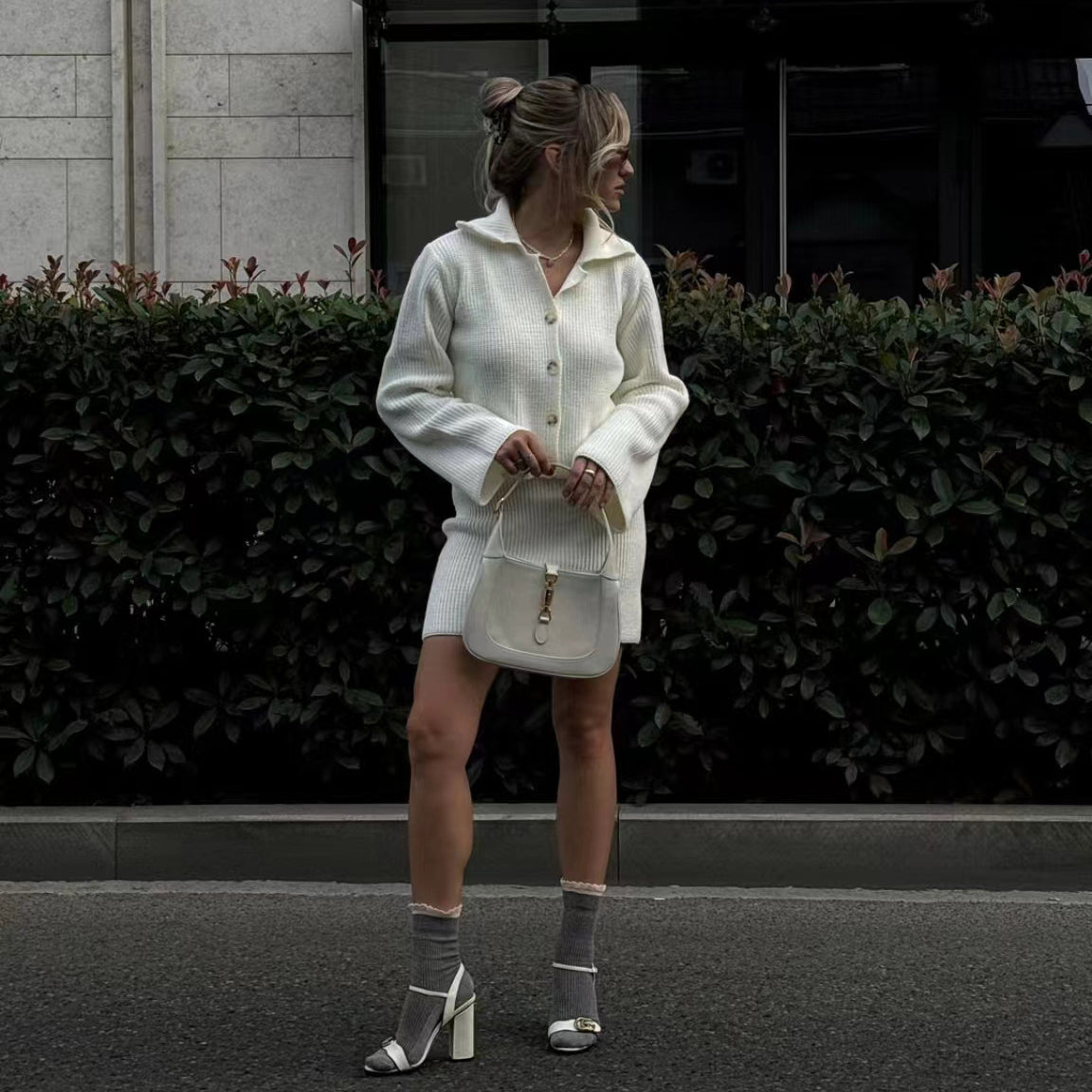 Elegant woman wearing white knit cardigan and skirt set in modern fashion style