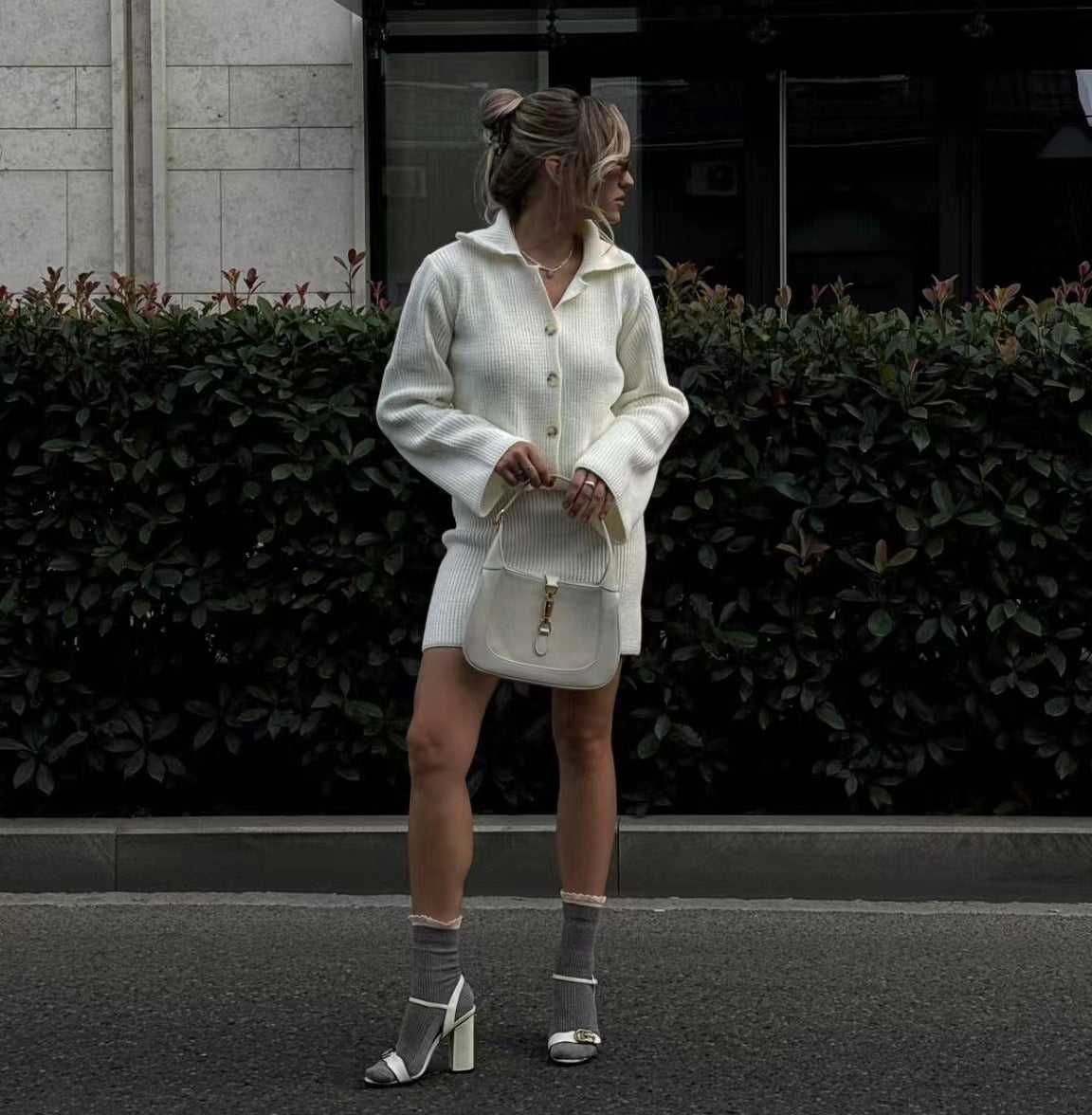 Elegant woman wearing white knit cardigan and skirt set in modern fashion style