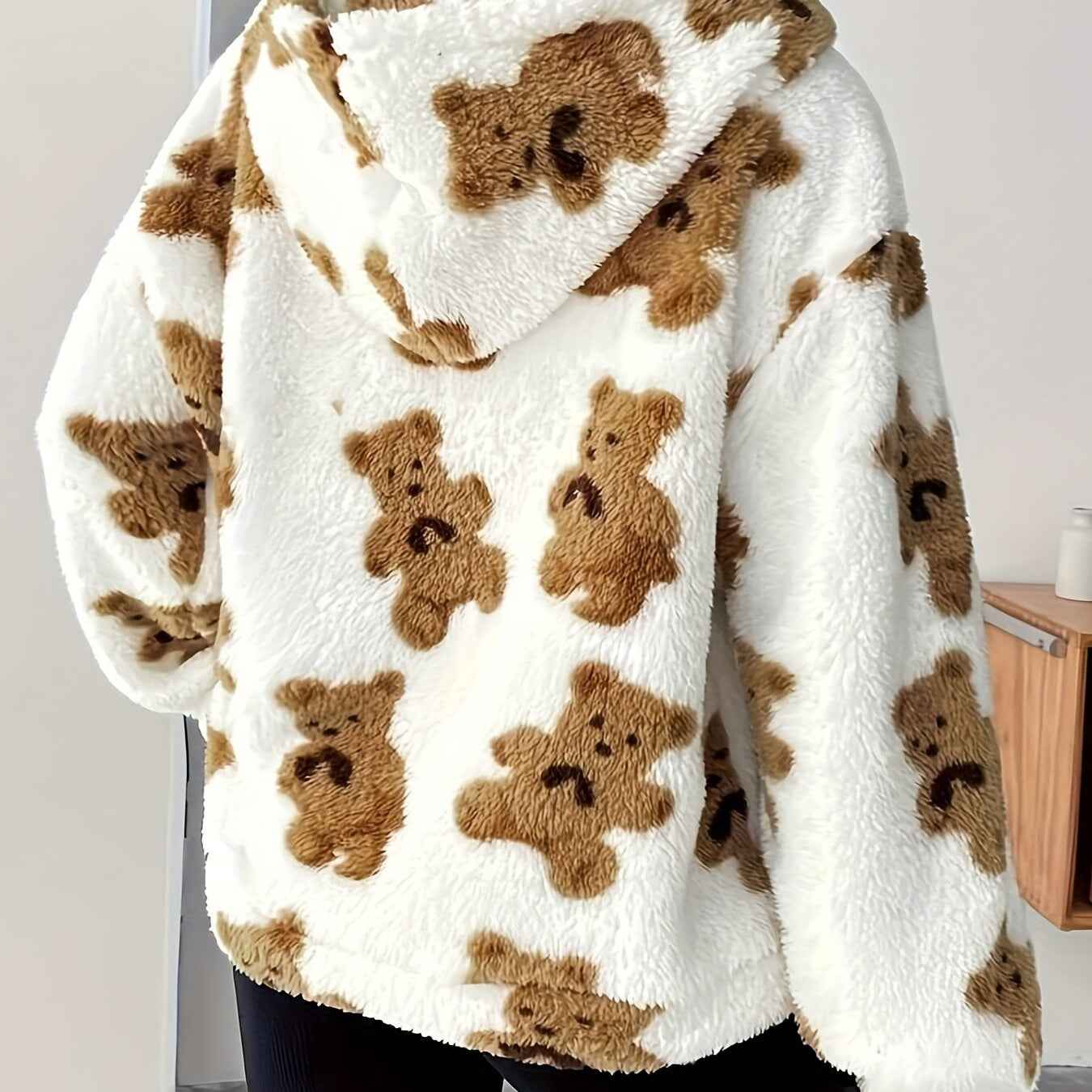 Fluffy white hoodie with brown teddy bear print, perfect for casual fashion ملابس