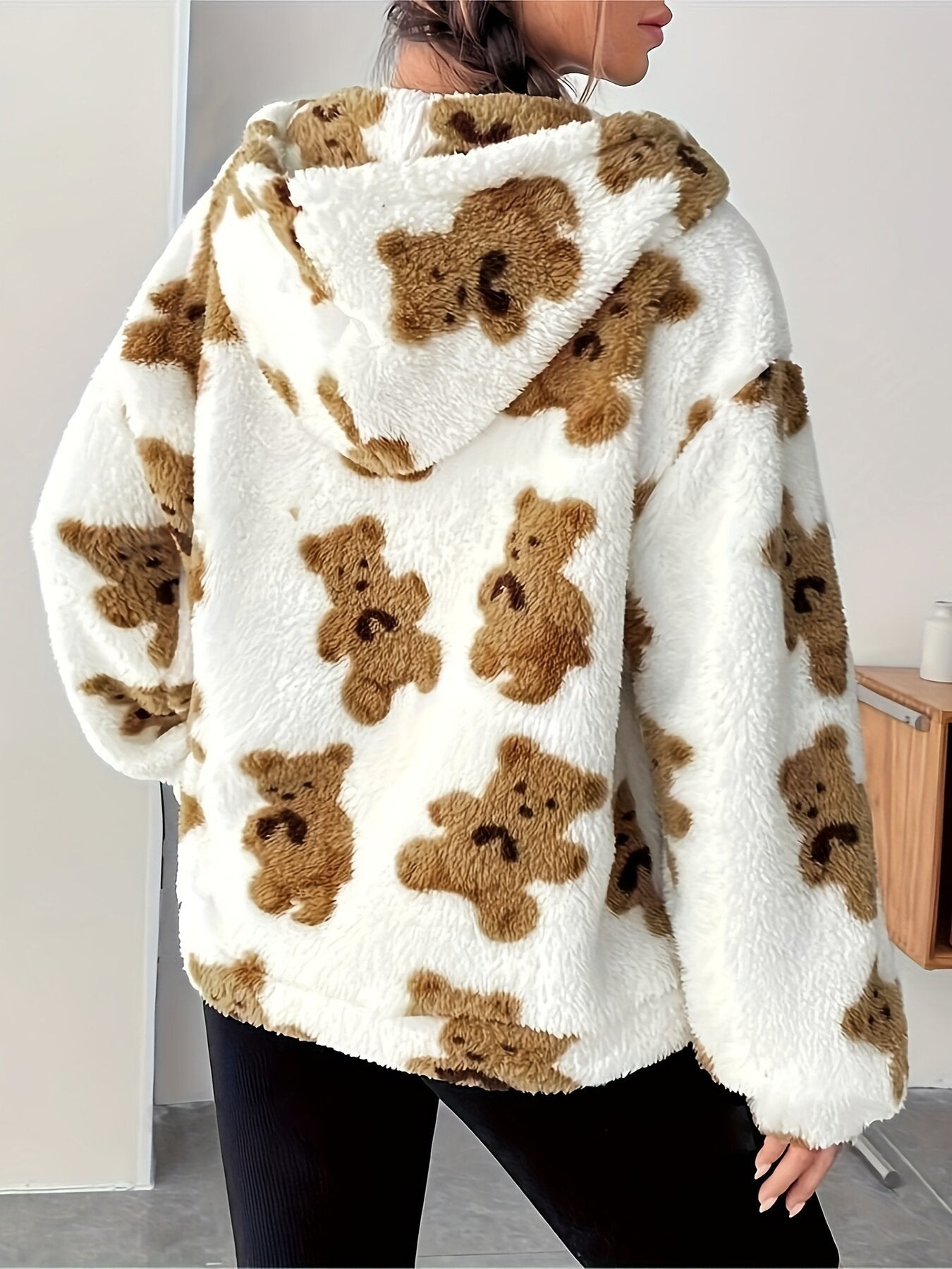Fluffy white hoodie with brown teddy bear print, perfect for casual fashion ملابس