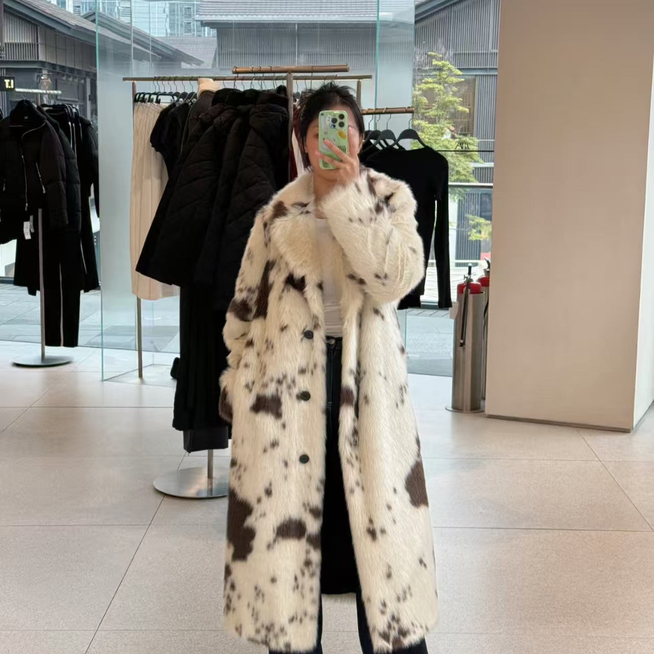 Cozy faux fur long coat in black and white cow print spots