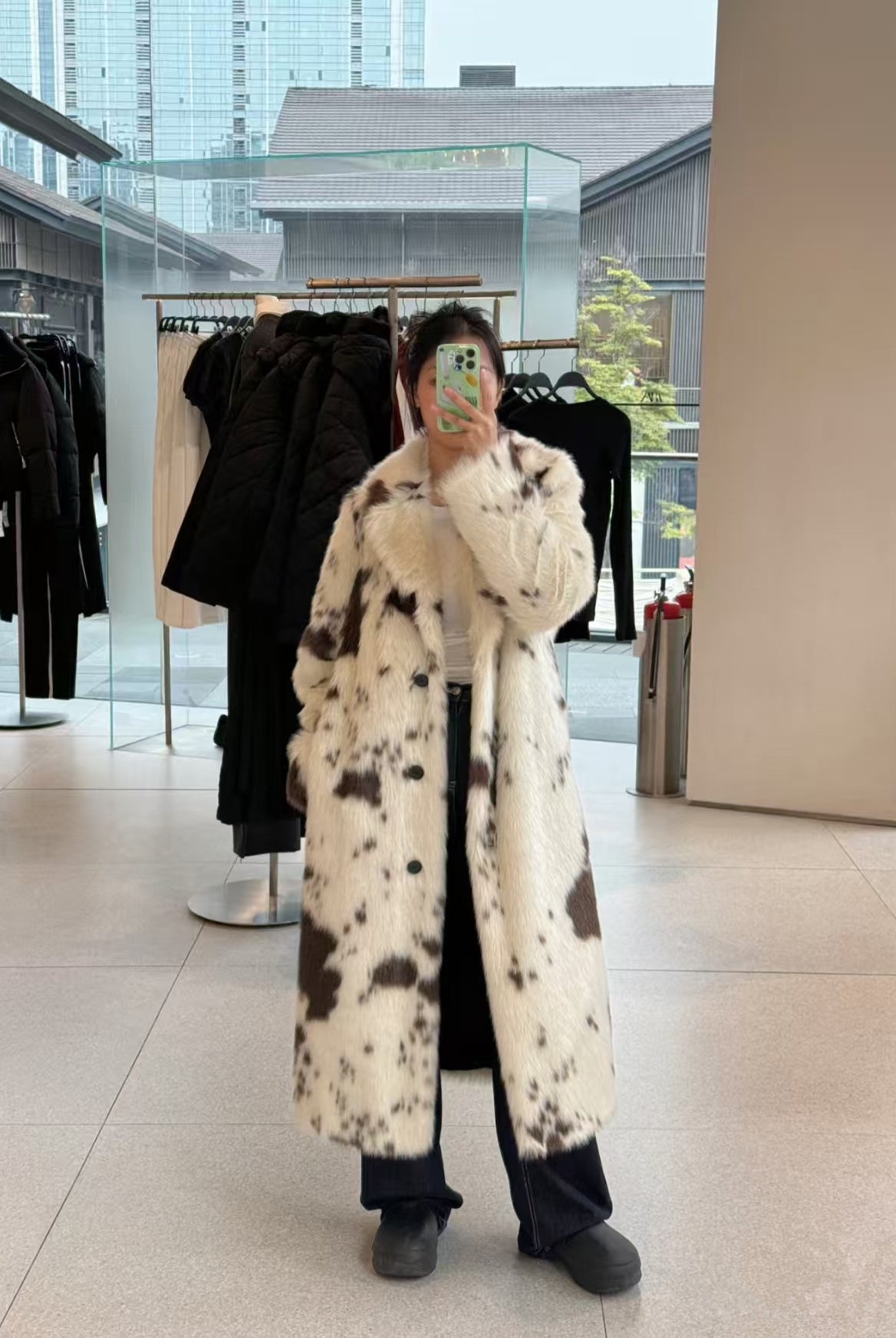 Cozy faux fur long coat in black and white cow print spots