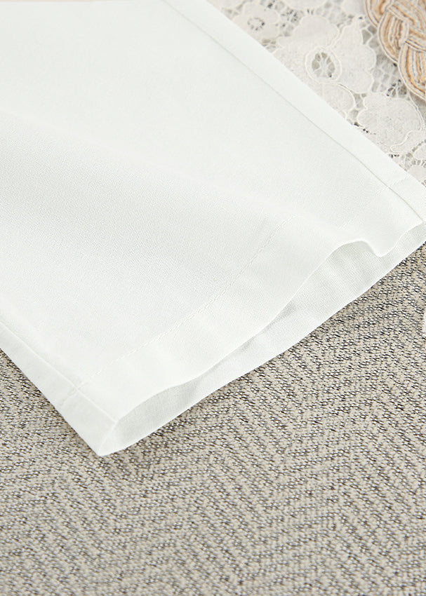 Crisp white cotton langry nightgown fabric with subtle texture and folded edge