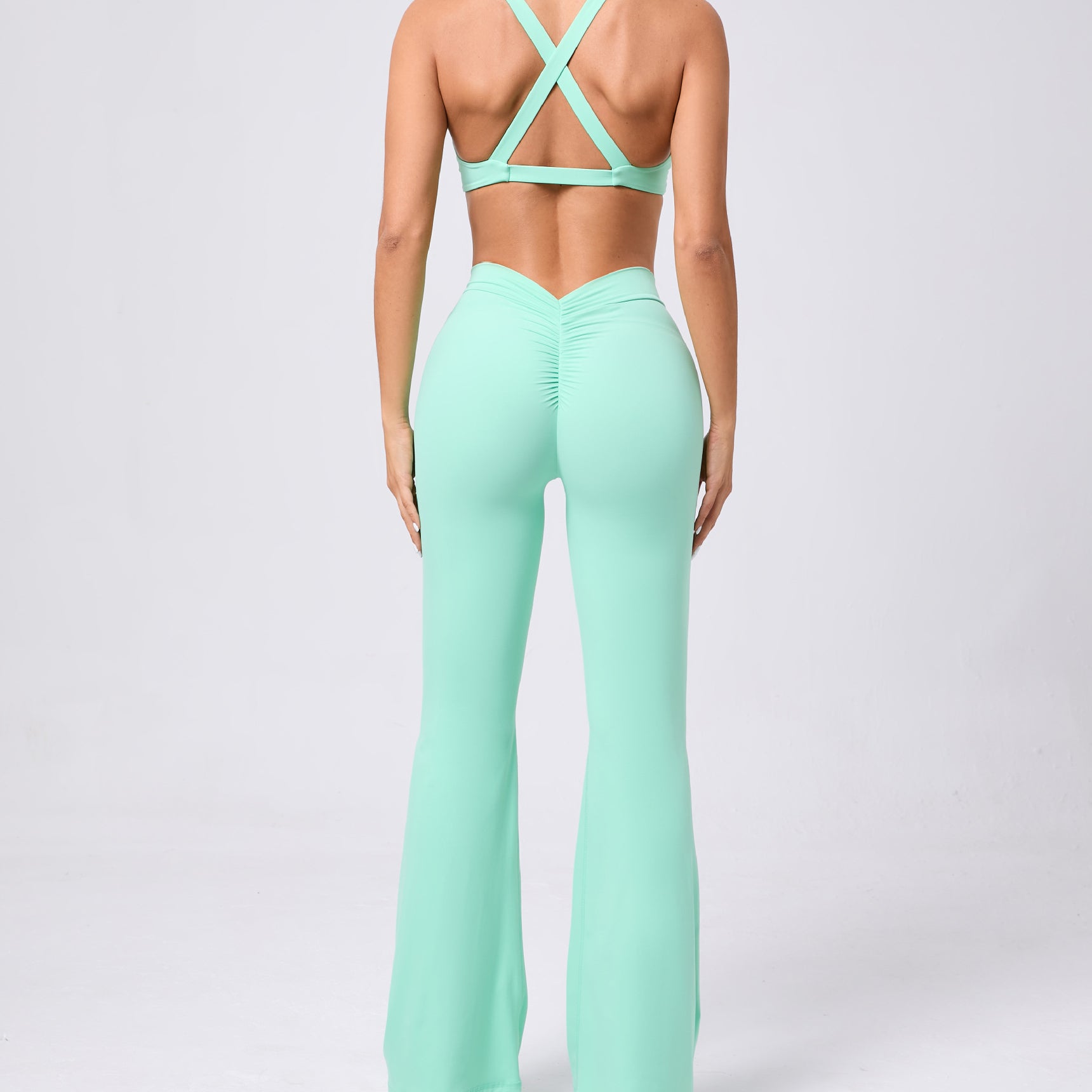 Peach tight brushed yoga hip raise flared jumpsuit with crisscross back