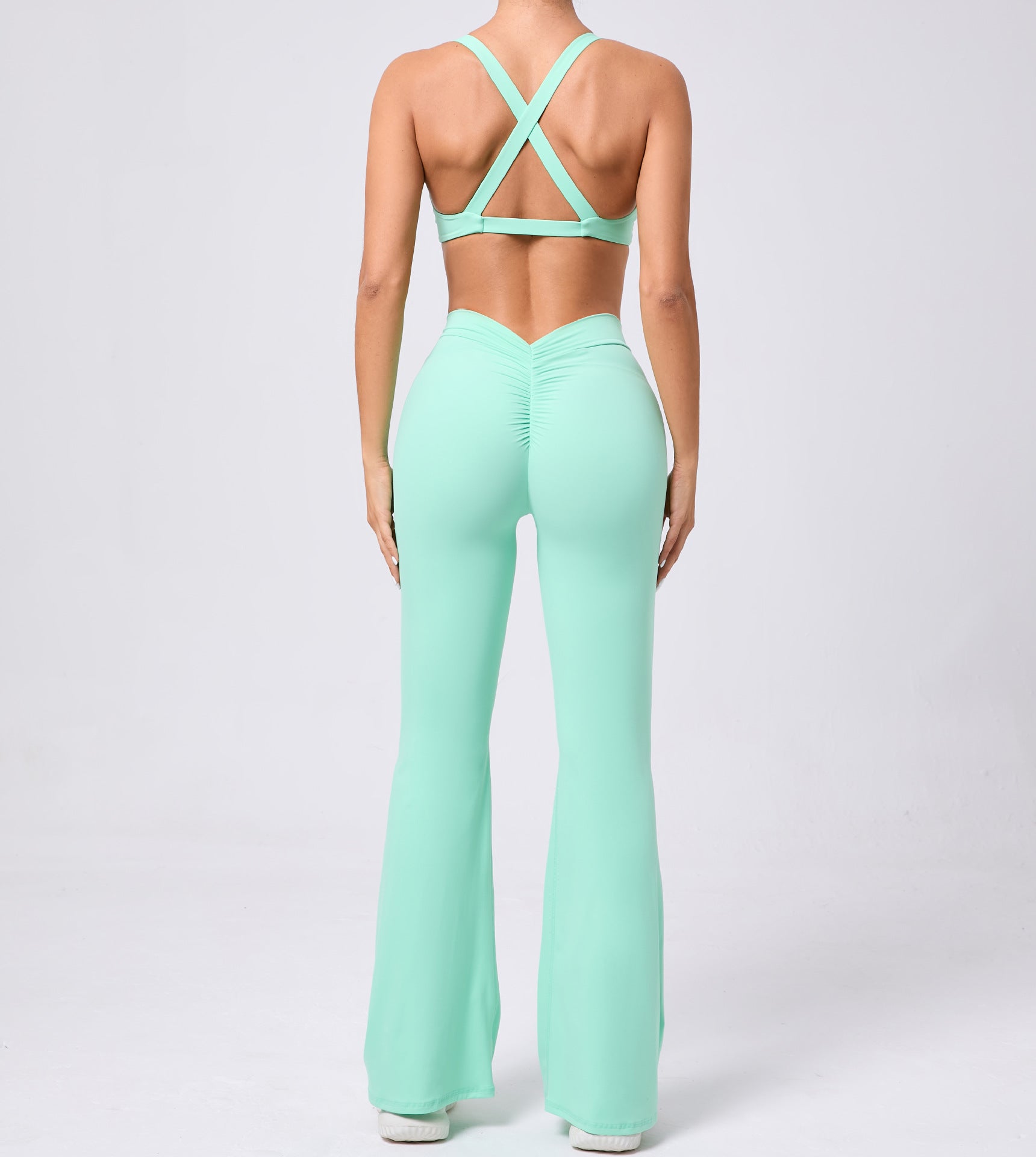 Peach tight brushed yoga hip raise flared jumpsuit with crisscross back