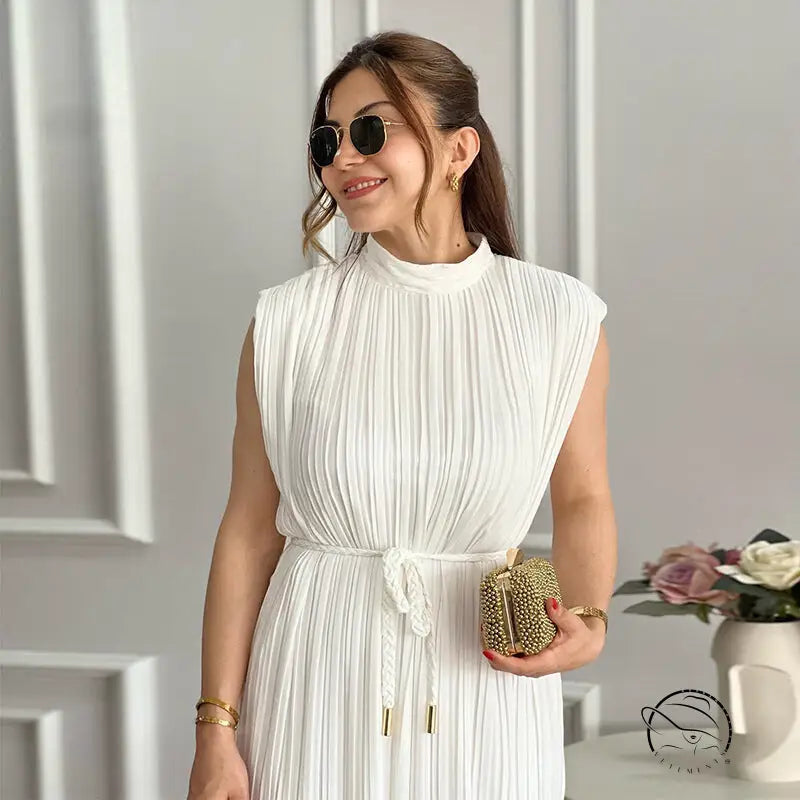 Pleated white mid length dress with gold accents and lace-up waist control
