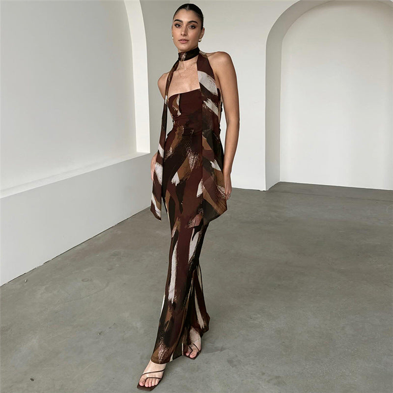 Sleek brown and white patterned halter maxi dress showcasing a fitted silhouette in fashion