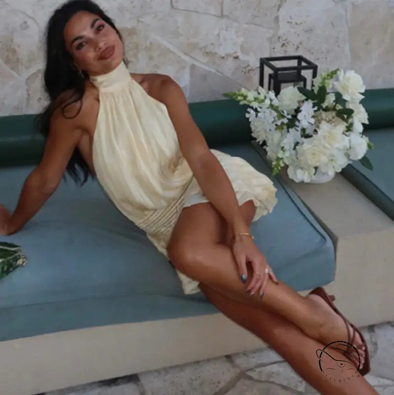 Woman in stunning backless mini dress with halter neck