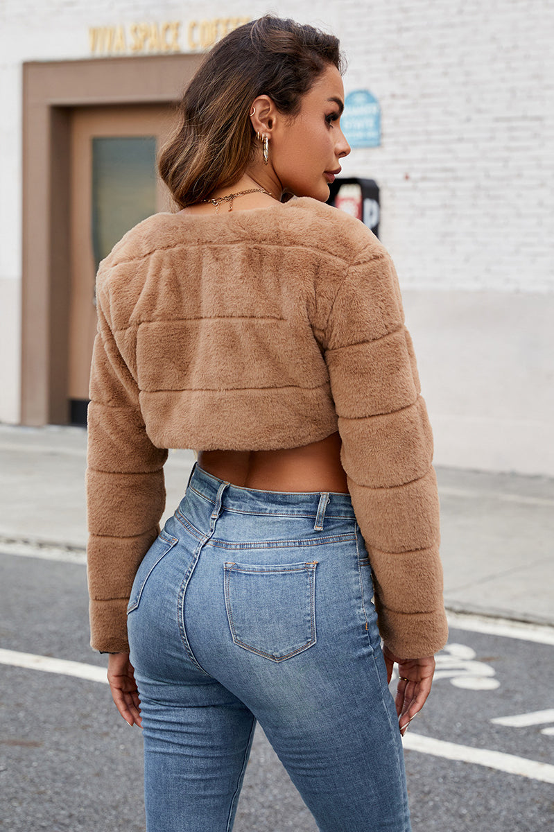 Tan faux fur cropped jacket with quilted panels and long sleeves