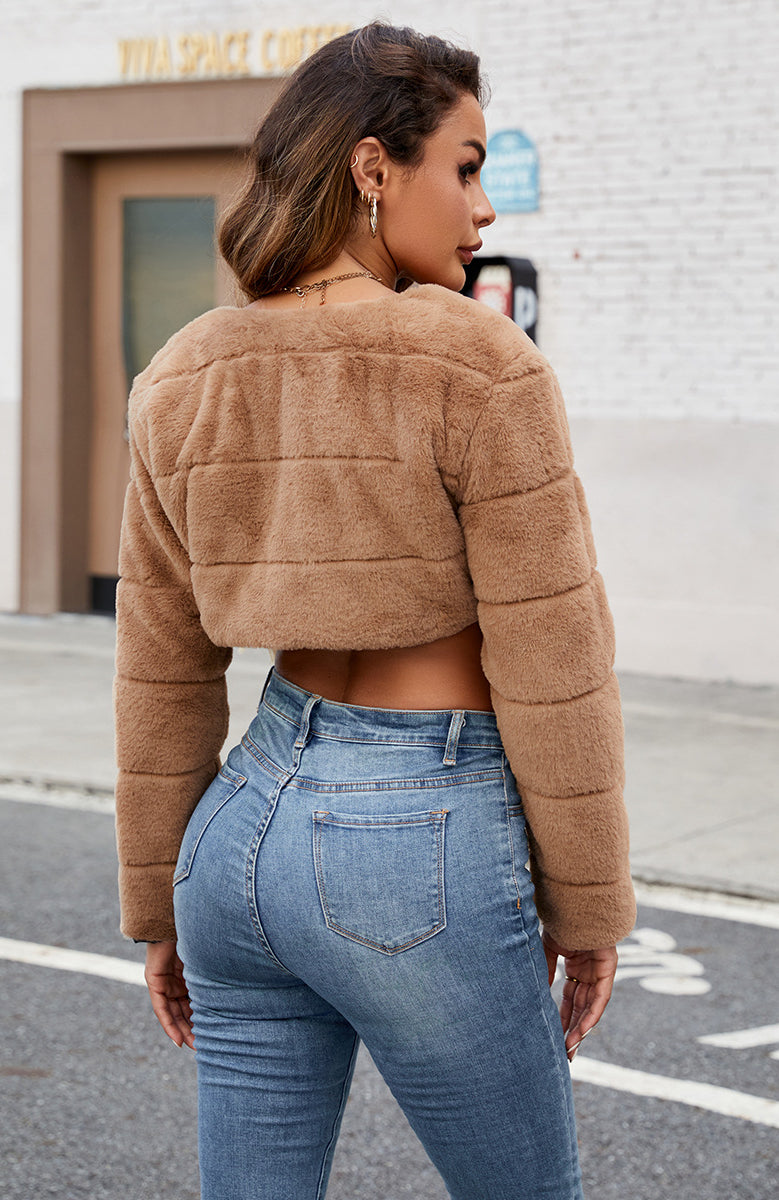 Tan faux fur cropped jacket with quilted panels and long sleeves