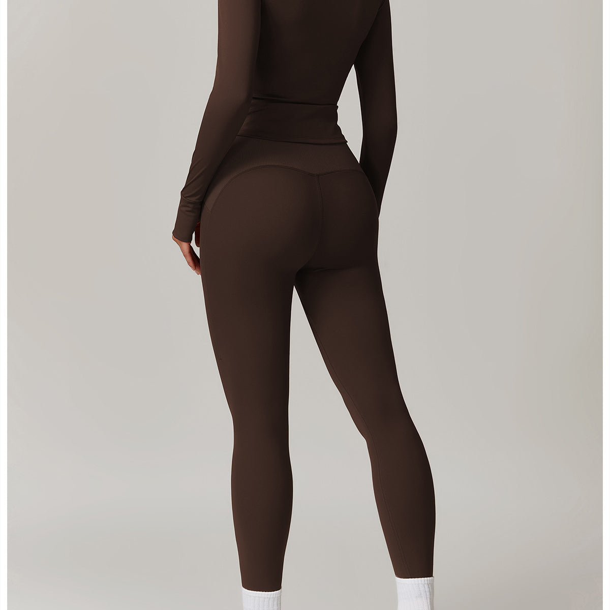Brown long-sleeved athletic jumpsuit with white socks and chunky sneakers for Langry fashion