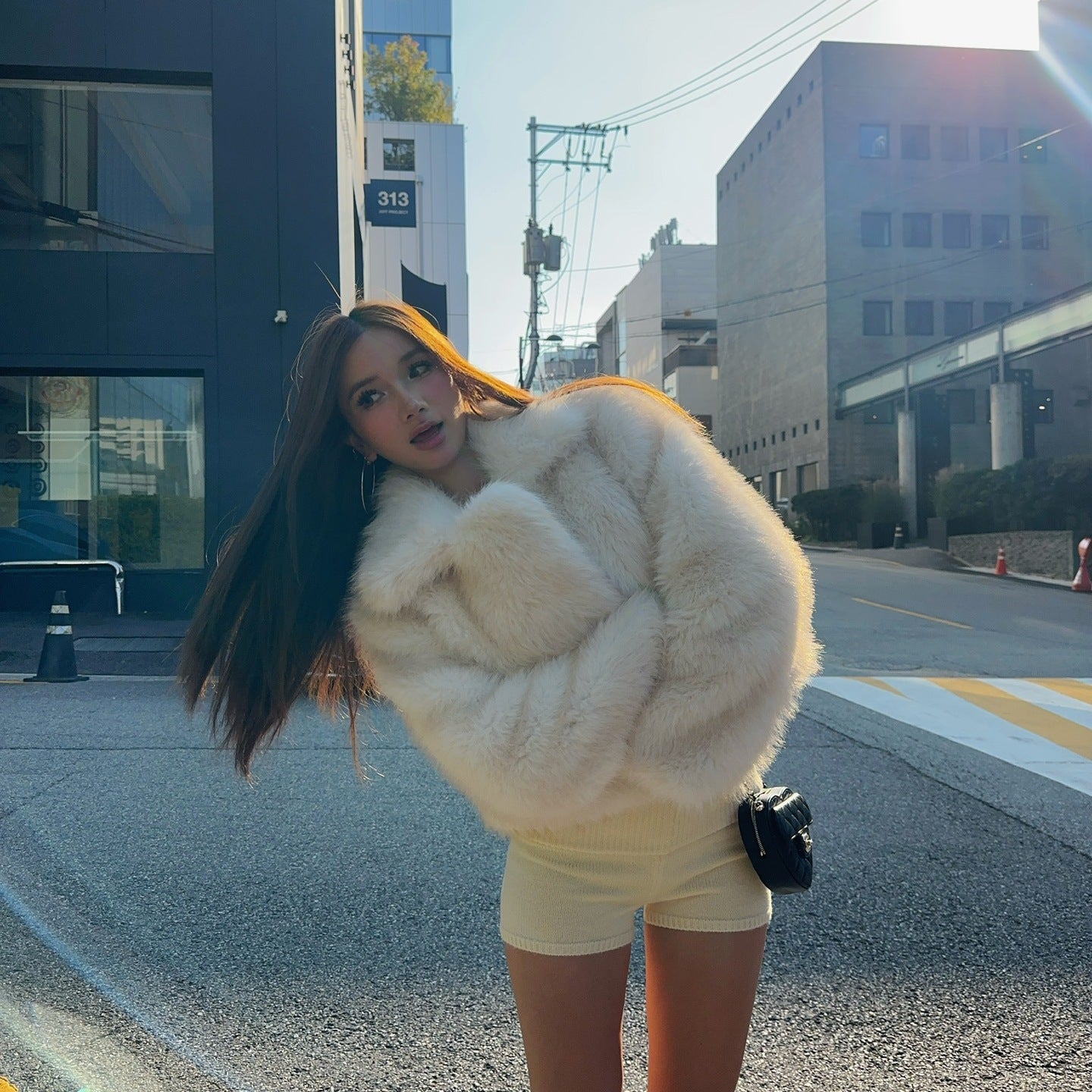 Short loose casual faux fur coat by Langry with cream fur, black trim, oversized design