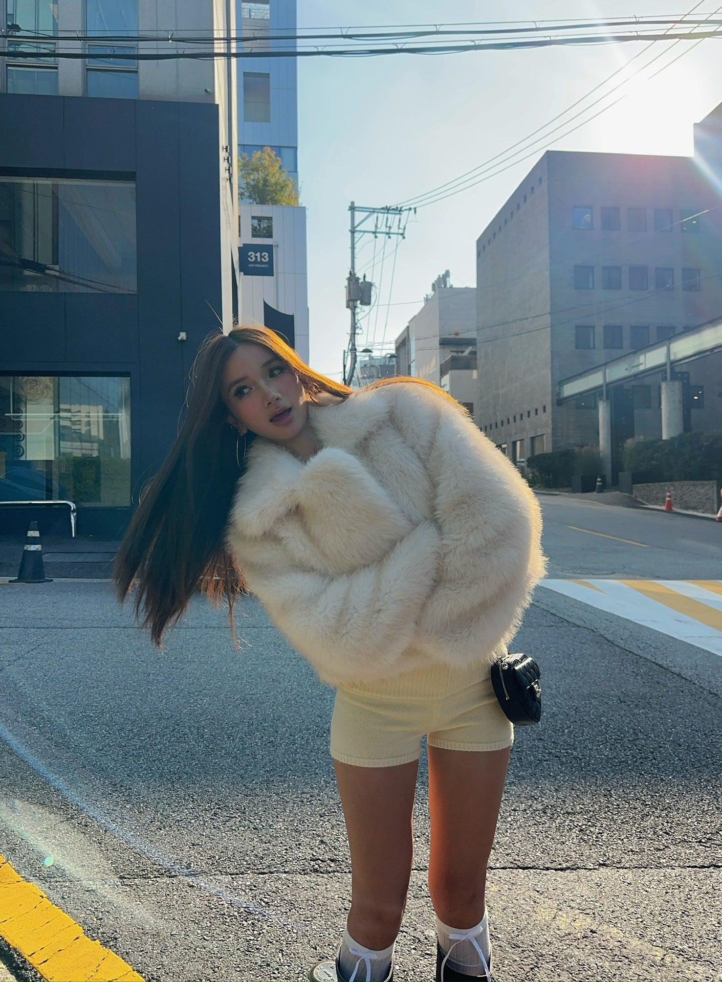 Short loose casual faux fur coat by Langry with cream fur, black trim, oversized design