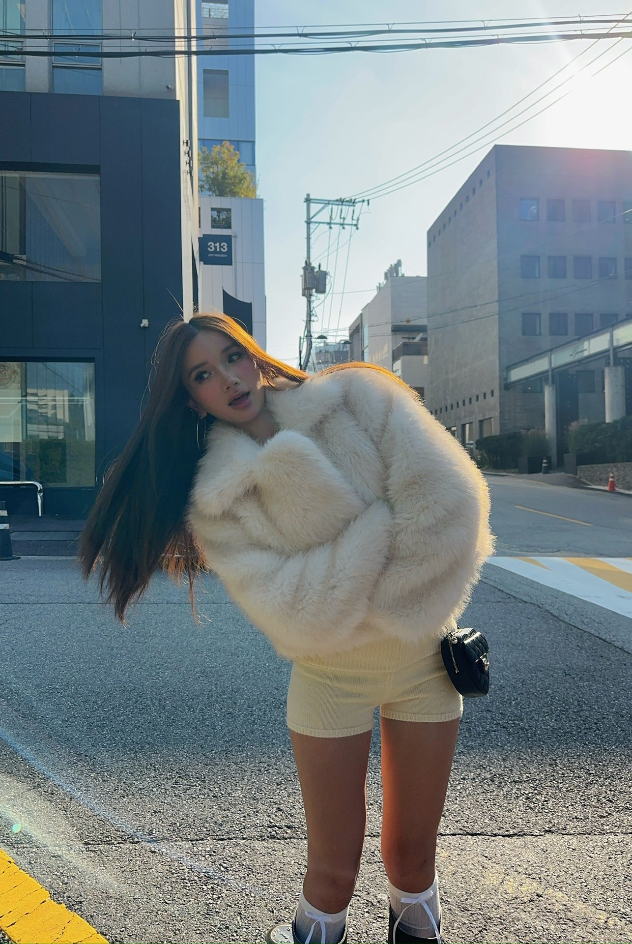 Short loose casual faux fur coat by Langry with cream fur, black trim, oversized design