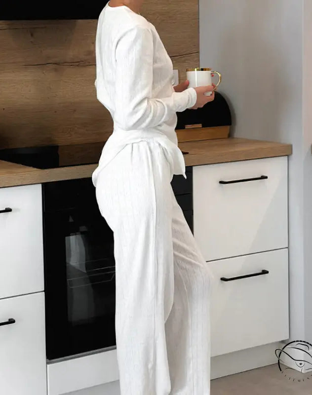 Woman in knitted jacquard pajamas with white ribbed top and wide-leg trousers