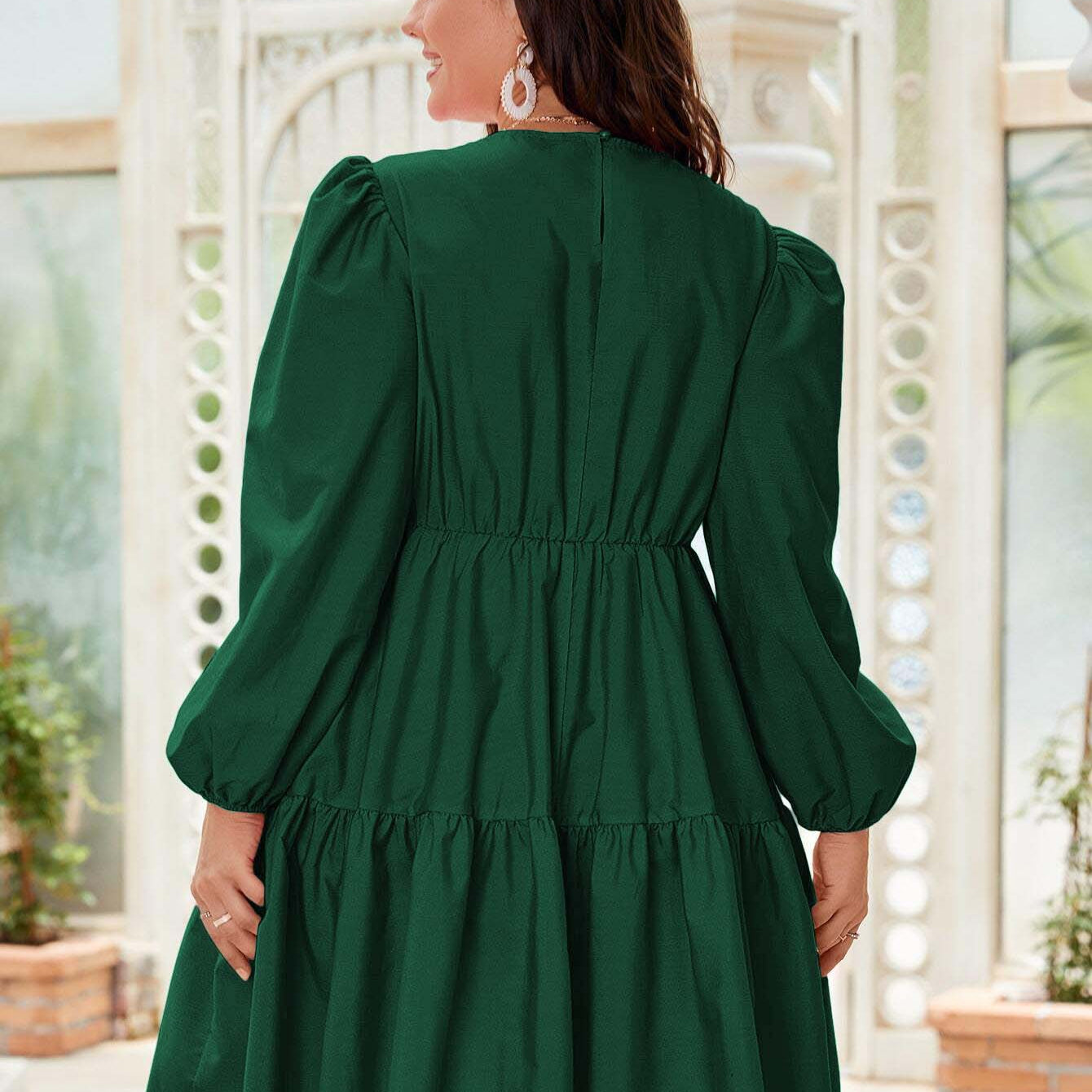 Emerald green tiered dress featuring stylish lantern sleeves for elegant fashion