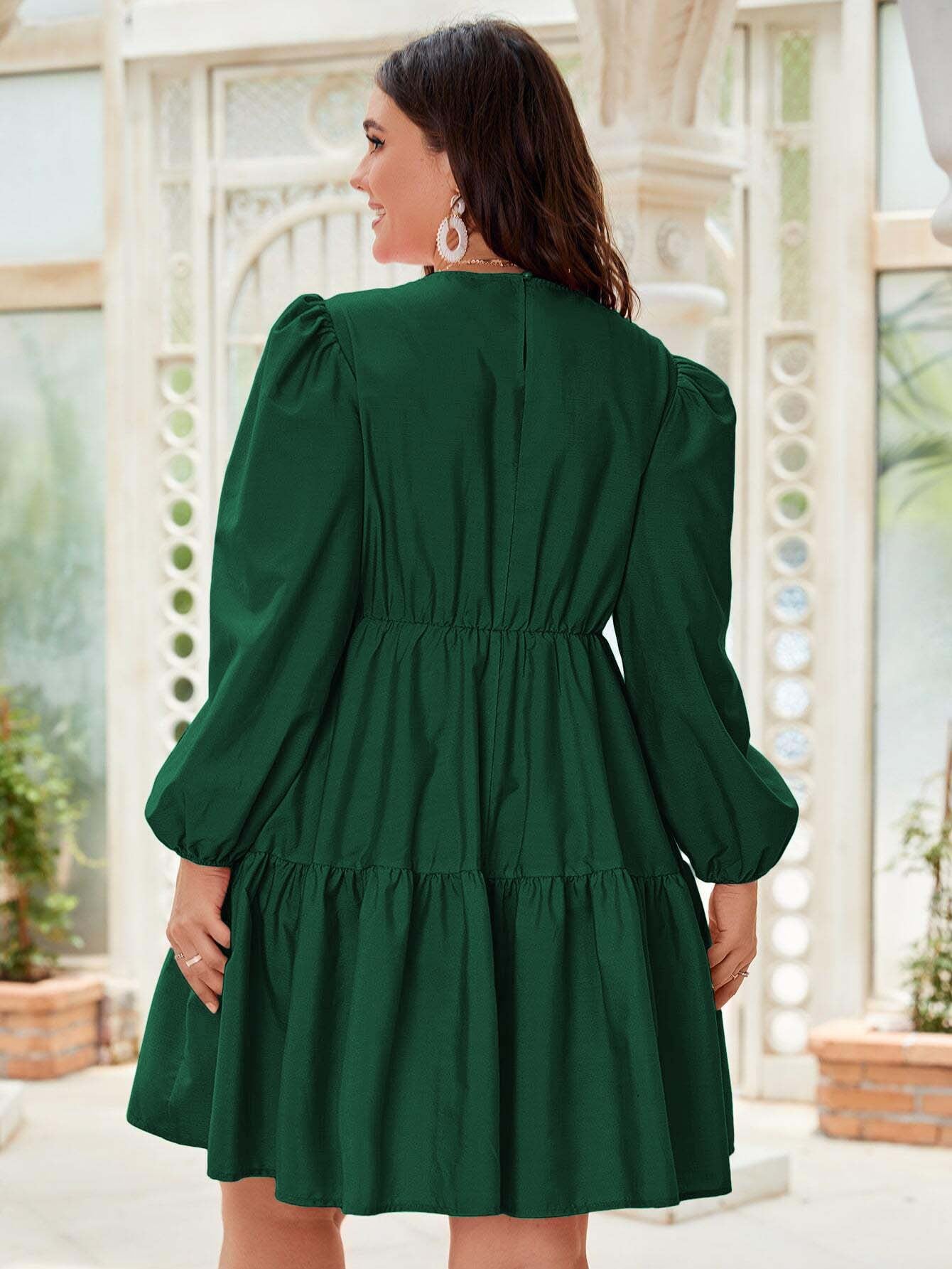 Emerald green tiered dress featuring stylish lantern sleeves for elegant fashion