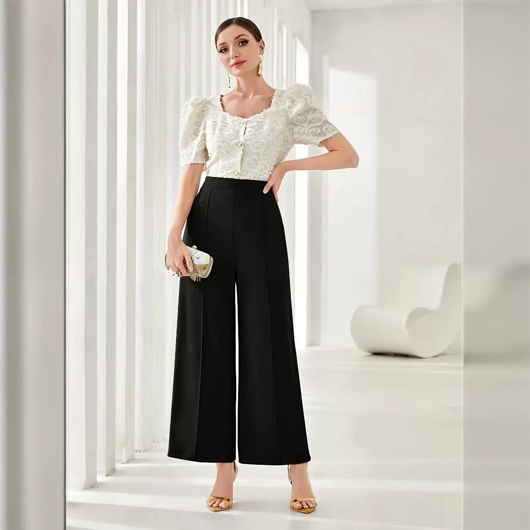 Elegant outfit showcasing a white puff-sleeve blouse with wide leg black palazzo pants