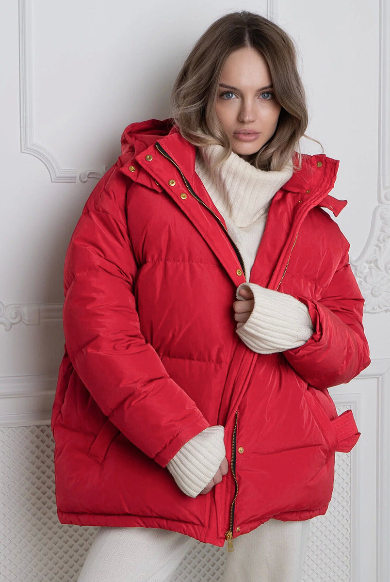 Woman modeling a red puffer jacket with cream turtleneck in Langry fashion style
