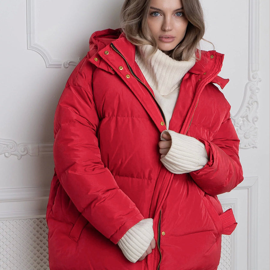 Woman modeling a red puffer jacket with cream turtleneck in Langry fashion style