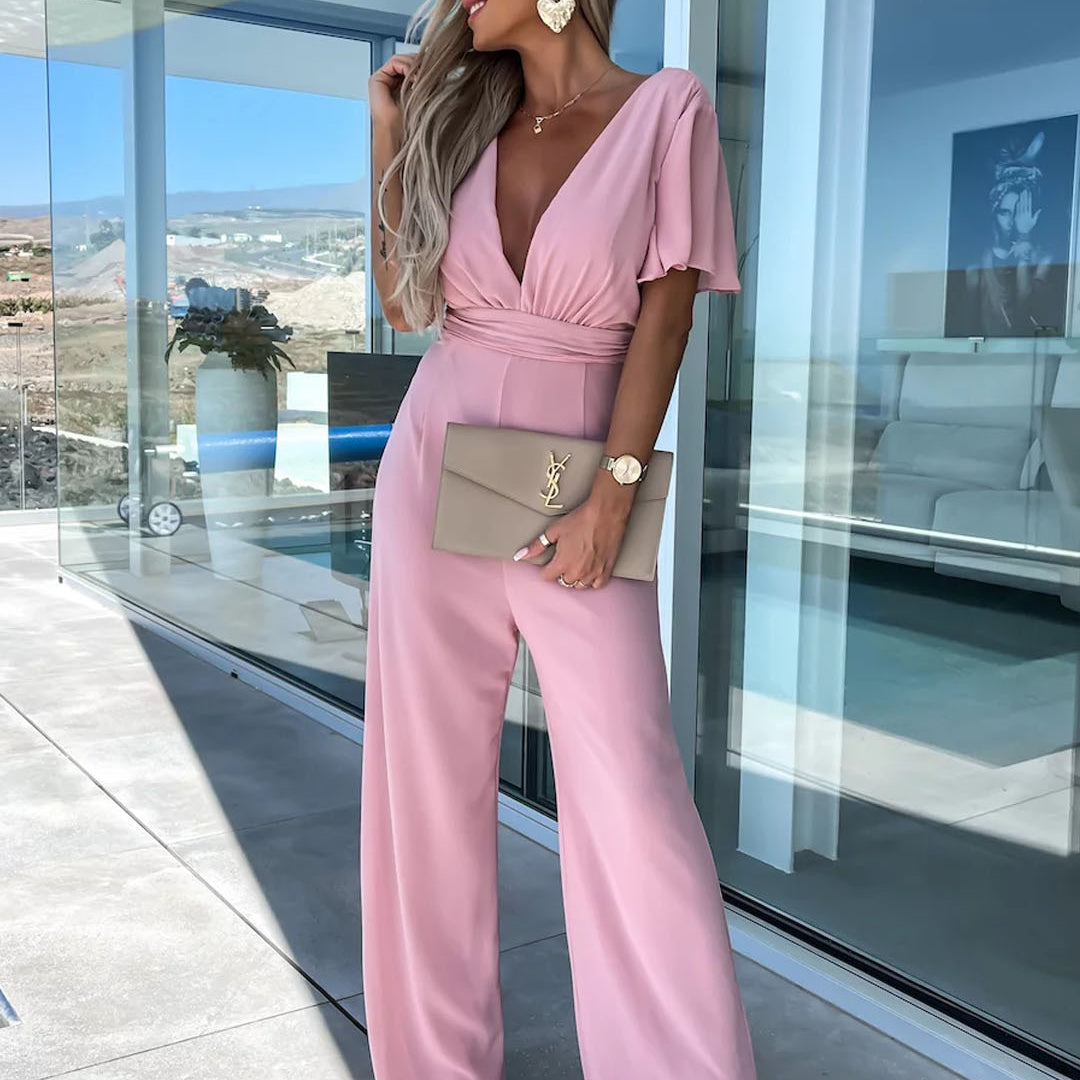 Woman in pink jumpsuit showcasing stylish Casual One Piece Trousers for modern fashion