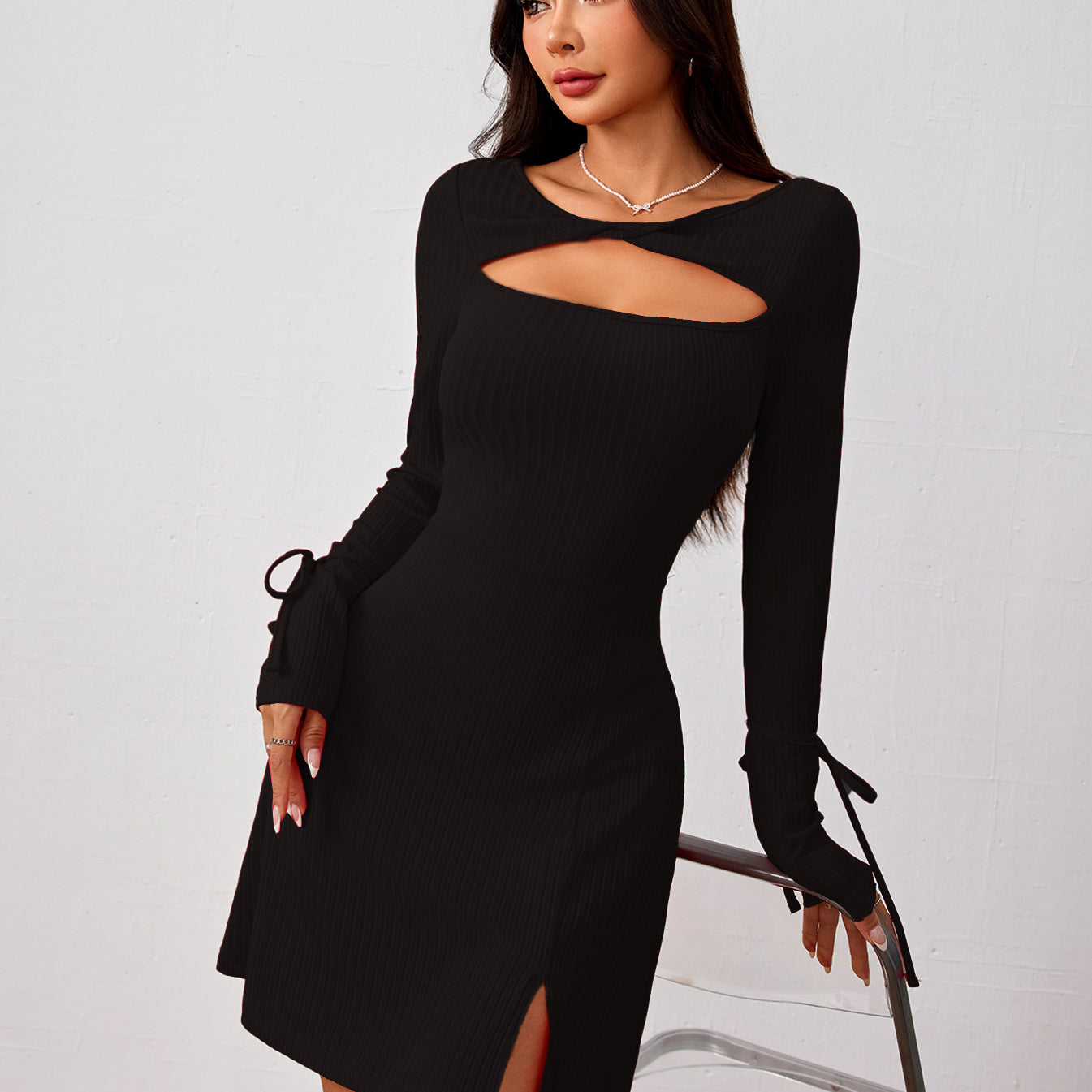 Black long-sleeved dress with cutout, side slit, and tie details in fashion ملابس style