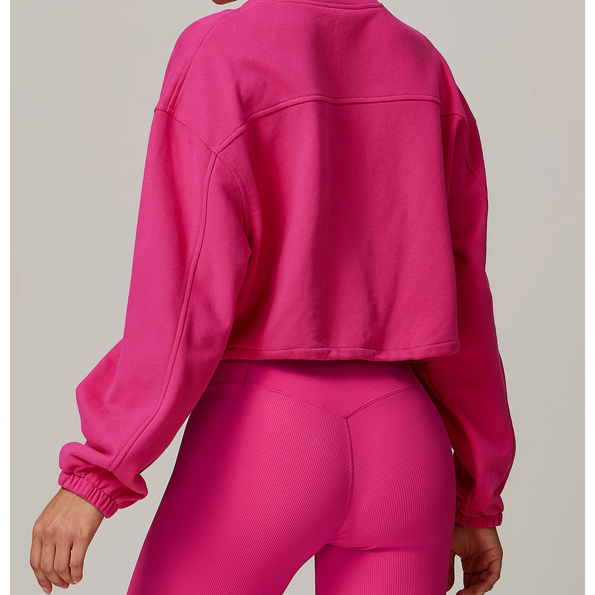 Hot pink cropped athletic jacket back view for stylish fitness and casual wear
