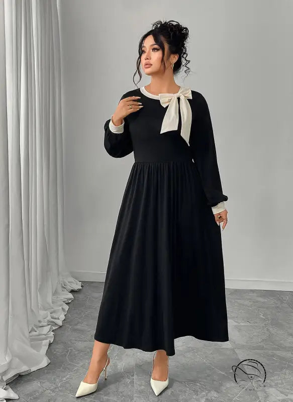 Winter retro slim black dress with long sleeves and white bow detail