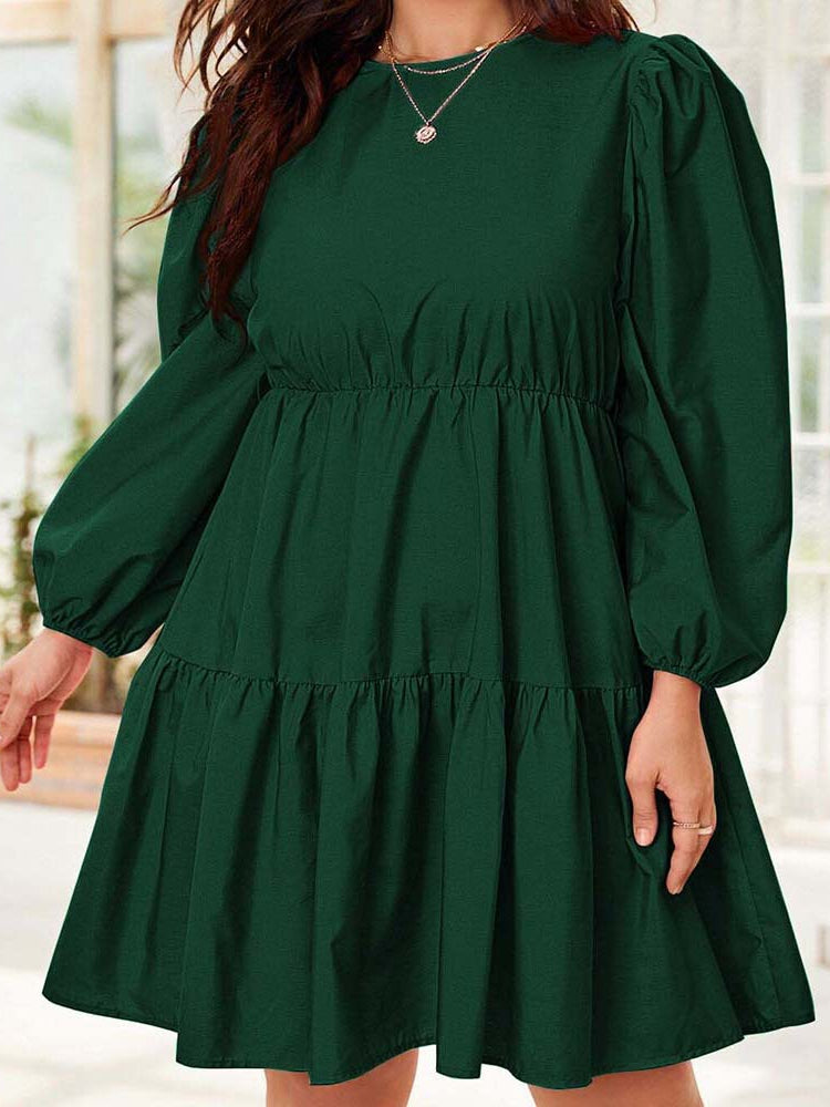 Emerald green tiered dress featuring elegant lantern sleeves, perfect for chic fashion statements